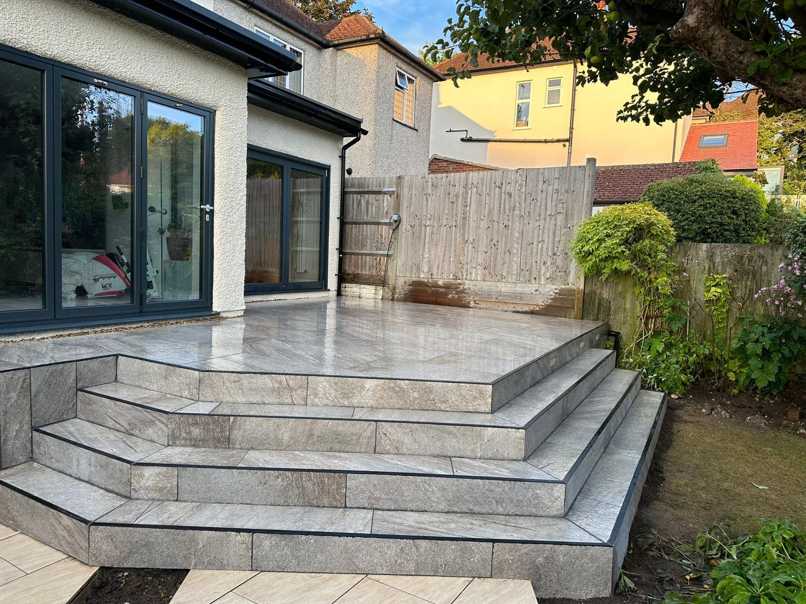 Patios Bexleyheath Wide paved steps leading from patio doors to a garden terrace